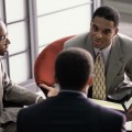 Three businessmen talking in a meeting